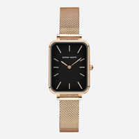 Vintage women's watch with a rectangular gold shape and fine mesh, deep black dial contrasted by a polished gold case.