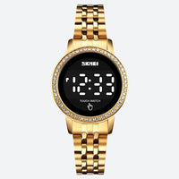 Women's Digital Watch in Retro-Chic Style, Metallic Gold Color on a Grey Background